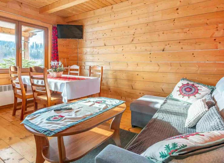 Na dole domku mieści się salon z sofą, jadalnią, TV i aneksem kuchennym