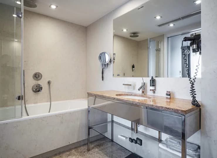 Łazienka w apartamencie posiada wannę z prysznicem