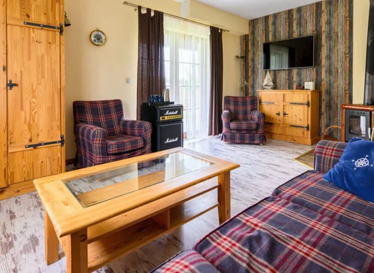 Przestronny apartament 2-pokojowy z kominkiem i tarasem ma duży salon z sofą